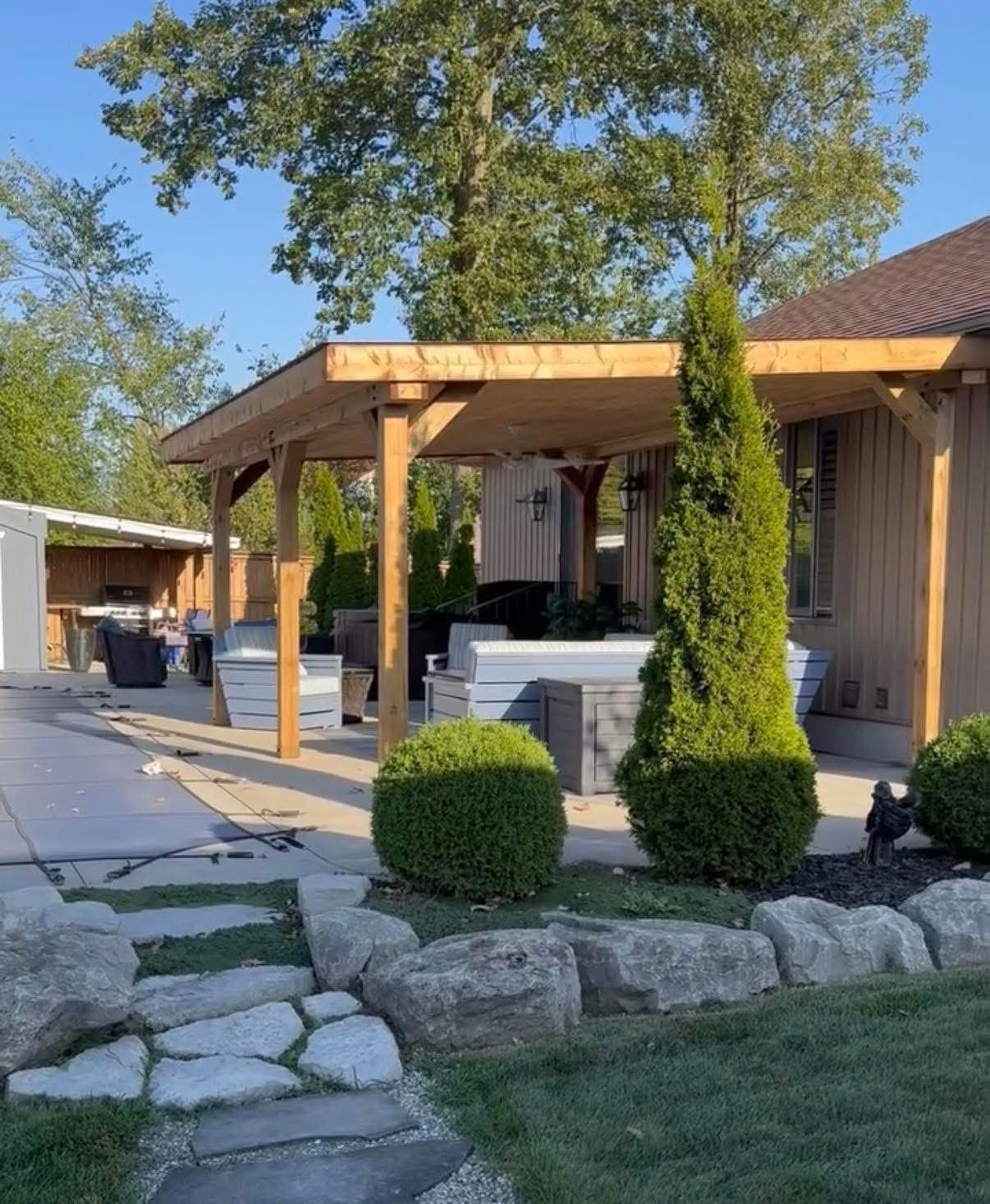 Completed timber-covered backyard patio by Back Country Contracting